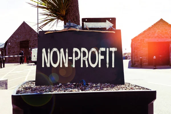 Text sign showing Non Profit. Conceptual photo type of organization that does not earn profits for its owners Empty black board with copy space for advertising. Blank dark board.