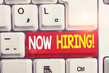 Şimdi İşe alma gösteren not yazma. İş fotoğrafı gelecekteki çalışanlarla iş ilişkisini değerlendirirken vitrinbeyaz arka plan üzerinde not kağıdı ile Beyaz pc klavye.