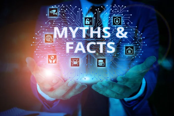 Word writing text Myths And Facts. Business concept for usually traditional story of ostensibly historical events Male human wear formal work suit presenting presentation using smart device. — Stock Photo, Image