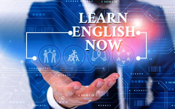 Writing note showing Learn English Now. Business photo showcasing gain or acquire knowledge and skill of english language Male wear formal work suit presenting presentation smart device. — ストック写真