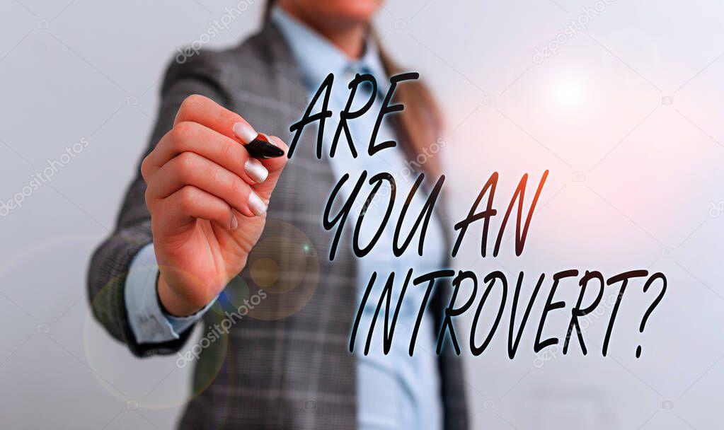 Conceptual hand writing showing Are You An Introvertquestion. Business photo text demonstrating who tends to turn inward mentally Business woman pointing in empty space with pen.