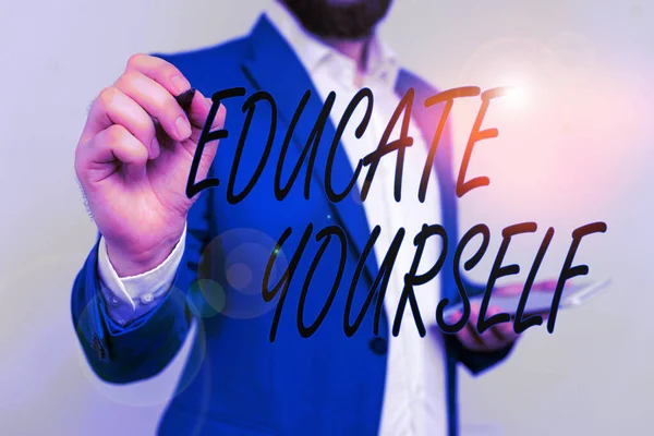 Text sign showing Educate Yourself. Conceptual photo prepare oneself or someone in a particular area or subject Businessman in blue suite and white shirt pointing with finger in empty space. — Stock Photo, Image