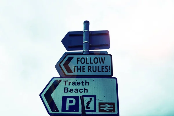 Writing note showing Follow The Rules. Business photo showcasing go with regulations governing conduct or procedure Business concept with empty copy space on the road sign.