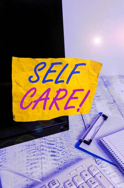 Conceptual hand writing showing Self Care. Business photo showcasing practice of taking action preserve or improve ones own health Note paper taped to black screen near keyboard stationary. — Stock Photo, Image