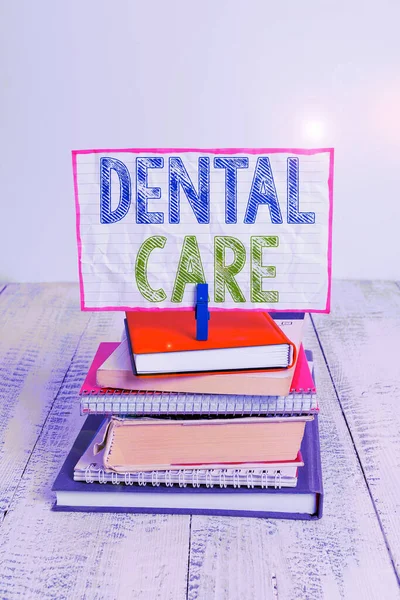 Word writing text Dental Care. Business concept for maintenance of healthy teeth or to keep it clean for future pile stacked books notebook pin clothespin colored reminder white wooden. — Stock Photo, Image