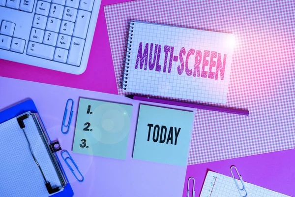 Text sign showing Multi Screen. Conceptual photo Having or involving several screen especially in a cinema Writing equipments and computer stuffs placed above colored plain table.