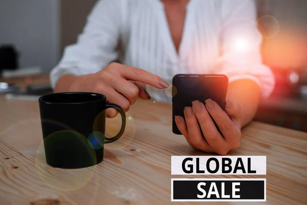 Text sign showing Global Sale. Conceptual photo analysisagers operations for companies do business internationally woman using smartphone office supplies technological devices inside home.