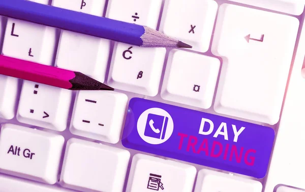 Writing note showing Day Trading. Business photo showcasing securities specifically buying and selling financial instruments White pc keyboard with note paper above the white background.