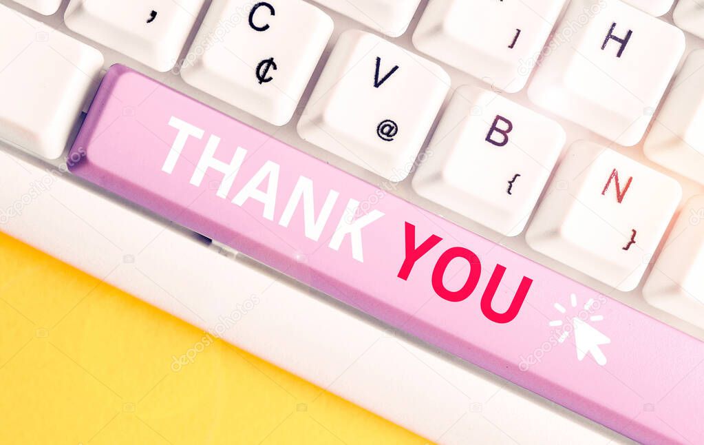 Writing note showing Thank You. Business photo showcasing polite expression used when acknowledging gift service compliment White pc keyboard with note paper above the white background.