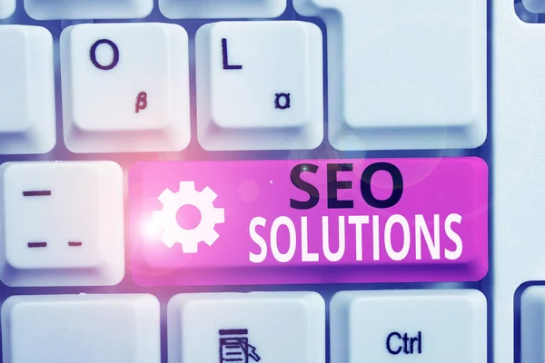Writing note showing Seo Solutions. Business photo showcasing Search Engine Result Page Increase Visitors by Rankings White pc keyboard with note paper above the white background. — Stock Photo, Image