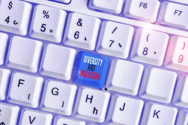 Writing note showing Diversity And Inclusion. Business photo showcasing range huanalysis difference includes race ethnicity gender White pc keyboard with note paper above the white background. — Stock Photo, Image