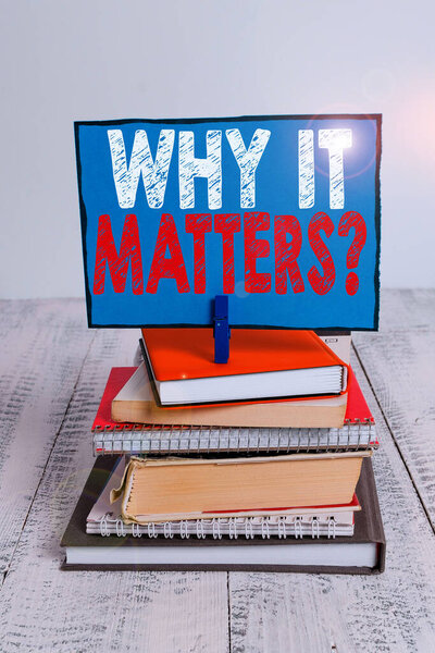Writing note showing Why It Matters Question. Business photo showcasing most important thing to be done when involved in situation pile stacked books notebook pin color reminder white wooden.