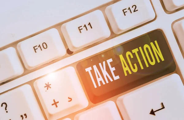 Writing note showing Take Action. Business photo showcasing to do somethingoract in order to get a particular result White pc keyboard with note paper above the white background. — Stock Photo, Image