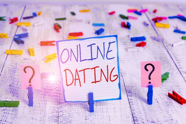 Konzeptionelle Handschrift, die Online-Dating zeigt. Geschäftsfotos, die die Suche nach passenden Beziehungen zeigen und Videochats mit zerbröselndem Blatt und Büroklammern auf dem Holztisch. — Stockfoto