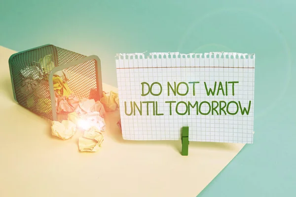 Text sign showing Do Not Wait Until Tomorrow. Conceptual photo needed to do it right away Urgent Better do now Trash bin crumpled paper clothespin empty reminder office supplies tipped.