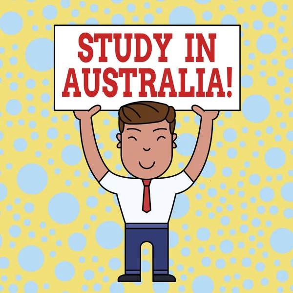 Word writing text Study in Australia. Business concept for going into foreign country order complete your studies Uśmiechnięty człowiek stojący trzymając duży pusty placyk nad głową obiema rękami. — Zdjęcie stockowe