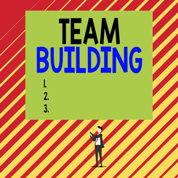 Text sign showing Team Building. Conceptual photo various types of activities used to enhance social relations Short hair immature young man stand in front of rectangle big blank board. — Stock Photo, Image