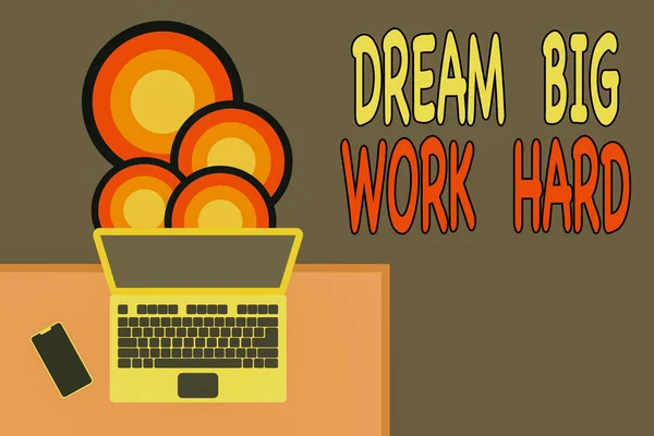 Handwriting text writing Dream Big Work Hard. Concept meaning Believe in yourself and follow the dreams and goals Upper view office working place laptop lying wooden desk smartphone side.