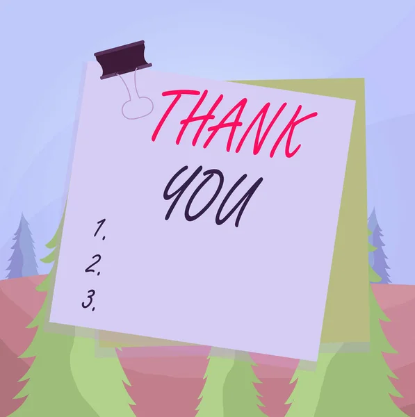 Word writing text Thank You. Business concept for a polite expression used when acknowledging a gift or service Paper stuck binder clip colorful background reminder memo office supply.