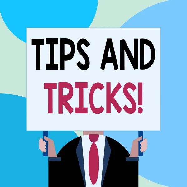 Handwriting text writing Tips And Tricks. Concept meaning means piece advice maybe suggestion how improve Just man chest dressed dark suit tie no face holding blank big rectangle. — Stock Photo, Image