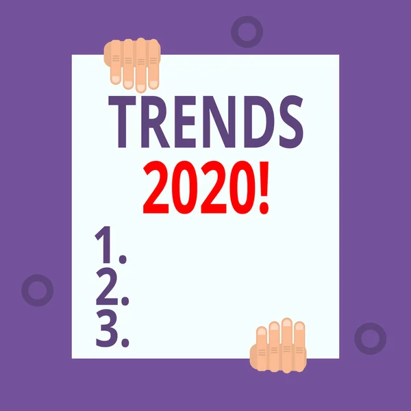 Schrijfnotitie met trends 2020. Bedrijfsfoto toont algemene richting waarin iets zich ontwikkelt of verandert Twee handen houden een grote lege blanco wit papier geplaatst op boven-en onderkant. — Stockfoto