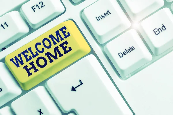 Handwriting text Welcome Home. Concept meaning Expression Greetings New Owners Domicile Doormat Entry White pc keyboard with empty note paper above white background key copy space.