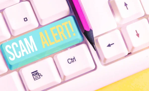 Handwriting text writing Scam Alert. Concept meaning fraudulently obtain money from victim by persuading him White pc keyboard with empty note paper above white background key copy space. — Stock Photo, Image