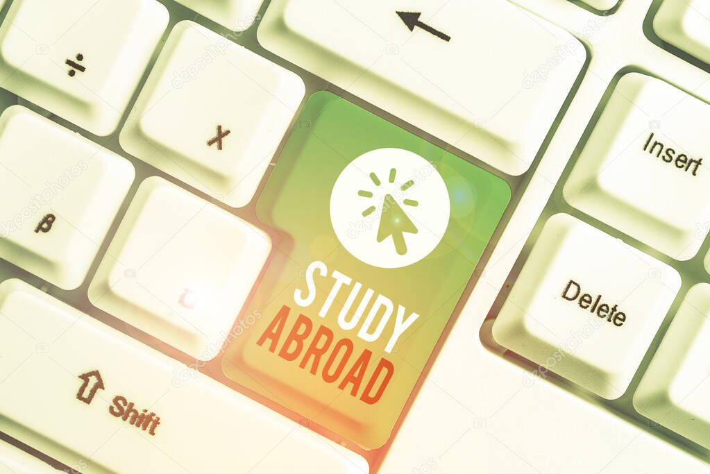 Writing note showing Study Abroad. Business photo showcasing Pursuing educational opportunities in a foreign country White pc keyboard with note paper above the white background.
