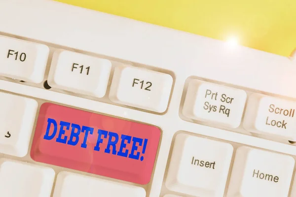 Writing note showing Debt Free. Business photo showcasing does not owning any money to any individual or companies White pc keyboard with note paper above the white background.