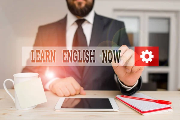 Handwriting text Learn English Now. Concept meaning gain or acquire knowledge and skill of english language Male human wear formal clothes present presentation use hi tech smartphone.