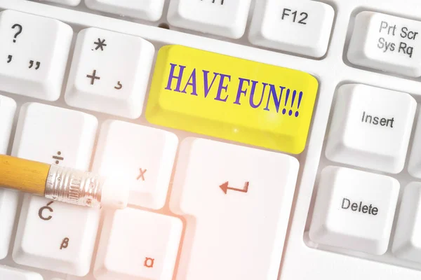 Writing note showing Have Fun. Business photo showcasing wish somebody good and enjoyable time when they do something White pc keyboard with note paper above the white background.