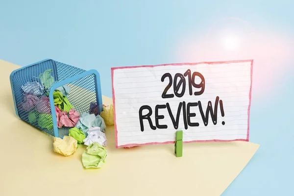 Conceptual hand writing showing 2019 Review. Business photo text remembering past year events main actions or good shows Trash bin crumpled paper clothespin reminder office supplies.