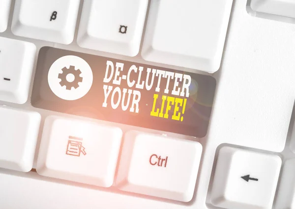 Word writing text De Clutter Your Life. Business concept for remove unnecessary items from untidy or overcrowded places White pc keyboard with empty note paper above white background key copy space. — Stock Photo, Image