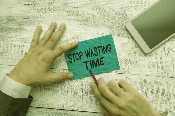 Text sign showing Stop Wasting Time. Conceptual photo advising demonstrating or group start planning and use it wisely Hand hold note paper near writing equipment and modern smartphone device. — Stock Photo, Image