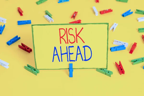 Word writing text Risk Ahead. Business concept for A probability or threat of damage, injury, liability, loss Colored clothespin papers empty reminder yellow floor background office. — Stock Photo, Image