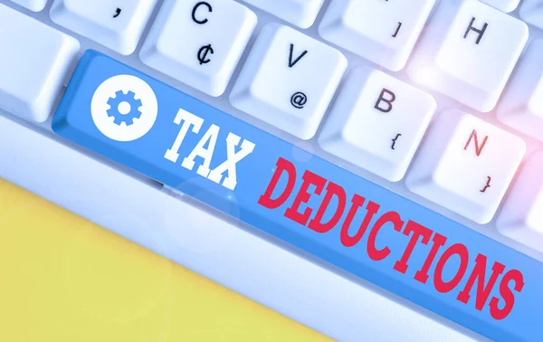 Conceptual hand writing showing Tax Deductions. Business photo text reduction income that is able to be taxed of expenses White pc keyboard with note paper above the white background. — Stock Photo, Image