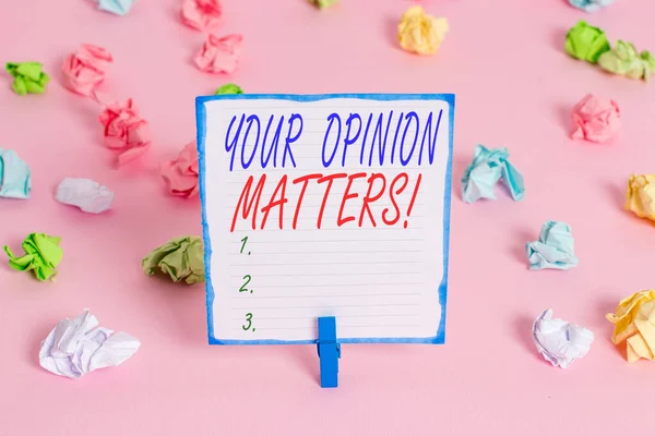 Handwriting text Your Opinion Matters. Concept meaning show you do not agree with something that just been said Colored crumpled papers empty reminder pink floor background clothespin.