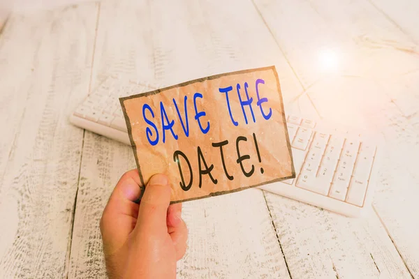 Conceptual hand writing showing Save The Date. Business photo text remember not schedule anything else on this day Man holding colorful reminder square shaped paper wood floor. — Stock Photo, Image