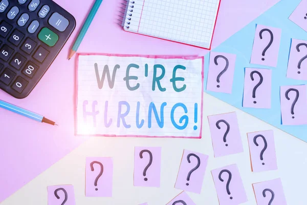 Handwriting text We Re Hiring. Concept meaning process of reviewing applications and finding candidates Mathematics stuff and writing equipment above pastel colours background.