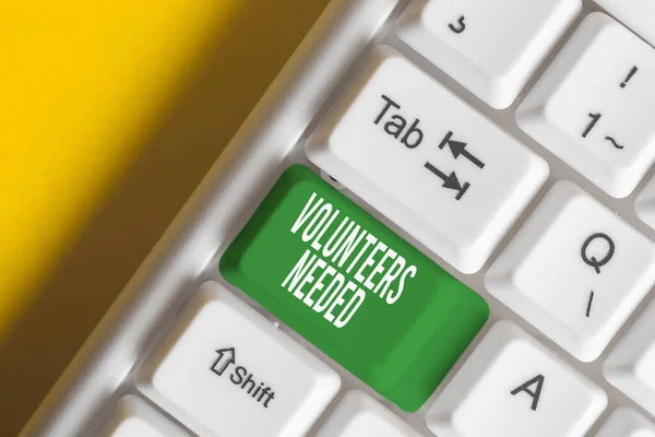 Text sign showing Volunteers Needed. Conceptual photo need work or help for organization without being paid White pc keyboard with empty note paper above white background key copy space. — Stock Photo, Image