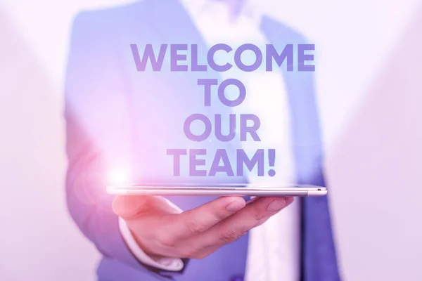 Writing note showing Welcome To Our Team. Business photo showcasing introducing another demonstrating to your team mates Man in the blue suite and white shirt holds mobile phone in the hand.