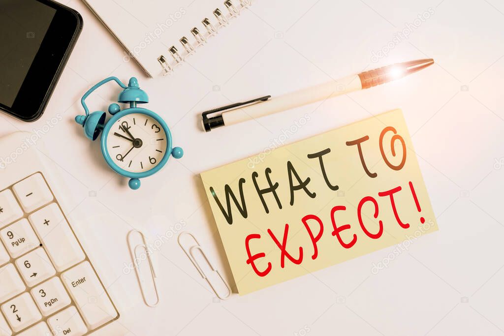 Text sign showing What To Expect. Conceptual photo asking about regard something as likely to happen occur Flat lay above computer mobile phone clock pencil and copy space note paper.