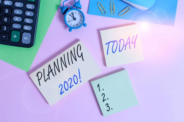 Text sign showing Planning 2020. Conceptual photo process of making plans for something next year Wire mouse portable calculator notepads paper sheets clips color background. — Stock Photo, Image