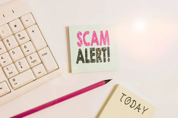 Text sign showing Scam Alert. Conceptual photo fraudulently obtain money from victim by persuading him White pc keyboard with empty note paper and pencil above white background.