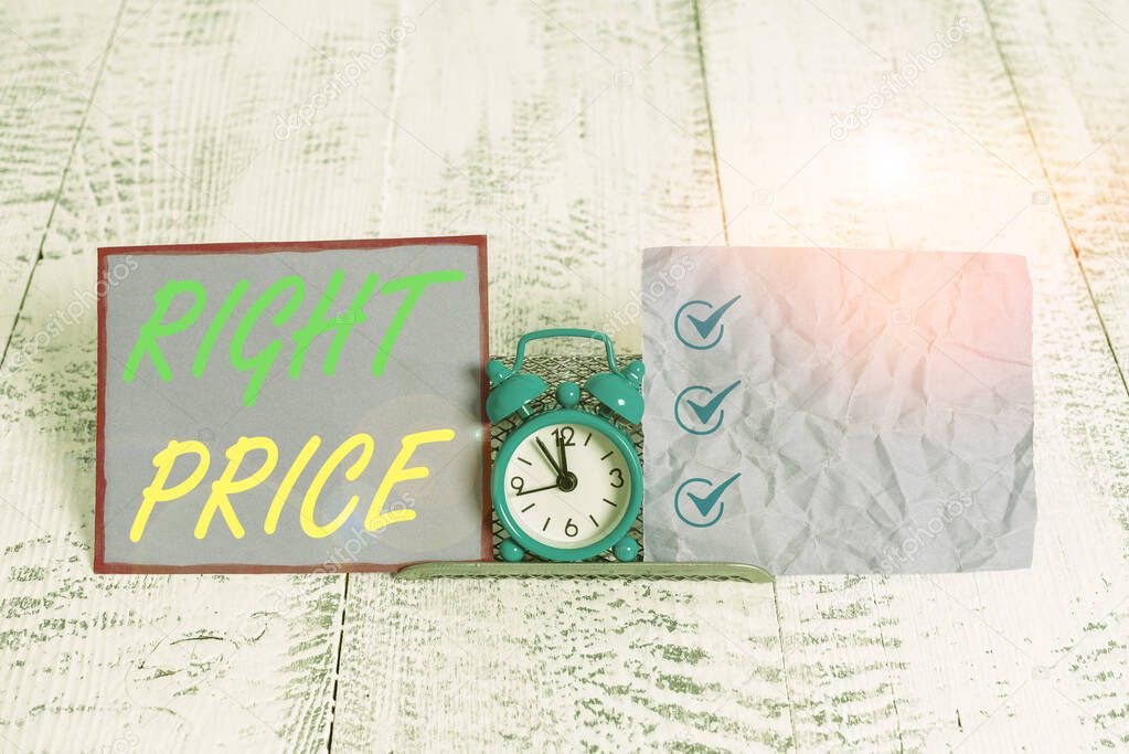 Text sign showing Right Price. Conceptual photo the amount of money that it is reasonable for the product Mini blue alarm clock standing above buffer wire between two notation paper.