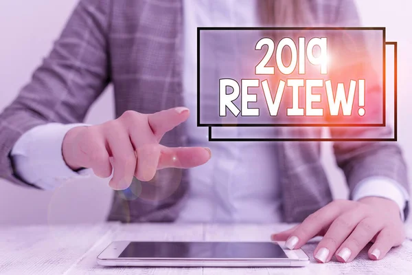 Writing note showing 2019 Review. Business photo showcasing remembering past year events main actions or good shows Business woman sitting with mobile phone on the table. — Stok fotoğraf