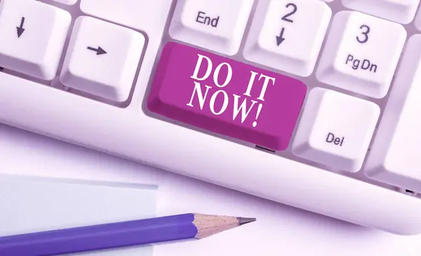 Text sign showing Do It Now. Conceptual photo not hesitate and start working or doing stuff right away White pc keyboard with empty note paper above white background key copy space. — Stock Photo, Image