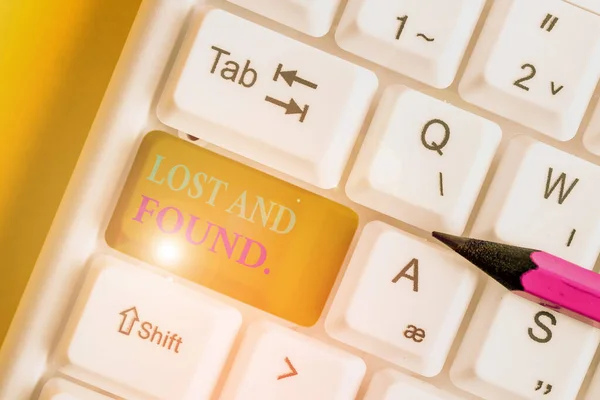 Conceptual hand writing showing Lost And Found. Business photo text a place where lost items are stored until they reclaimed White pc keyboard with note paper above the white background.