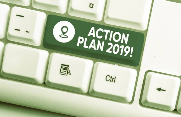 Writing note showing Action Plan 2019. Business photo showcasing proposed strategy or course of actions for current year White pc keyboard with note paper above the white background.