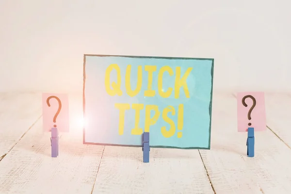 Text sign showing Quick Tips. Conceptual photo small but particularly useful piece of practical advice Scribbled and crumbling sheet with paper clips placed on the wooden table.